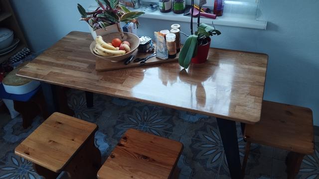 Oak kitchen table with a brown stain and mirror like lacquer